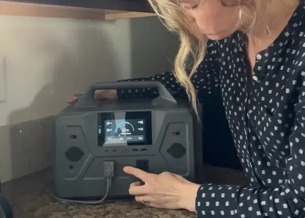 A woman charging her 4Patriots Patriot Power Generator 1200 in her kitchen