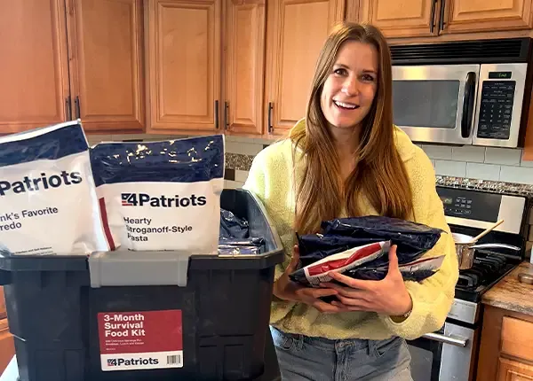 A female customer with the 4Patriots 3-Month survival food kit in her kitchen