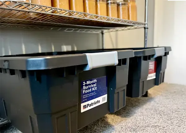 The 4Patriots 3-Month Food Kit stored at the bottom of a shelf in a prep closet