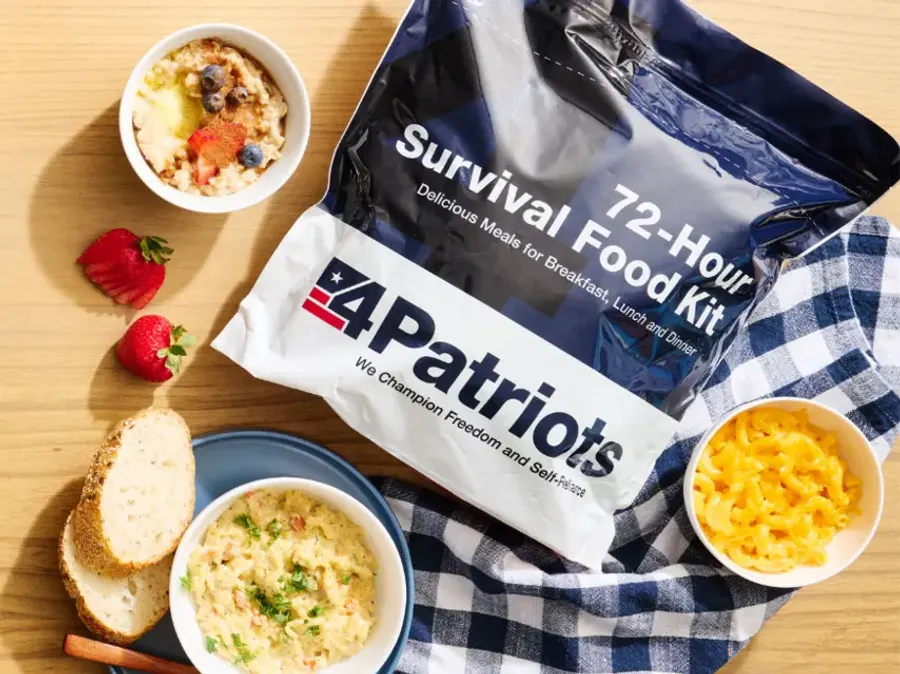 An open package of 4Patriots Emergency Food Bars rests against a man’s leg at a campsite in the outdoors.
