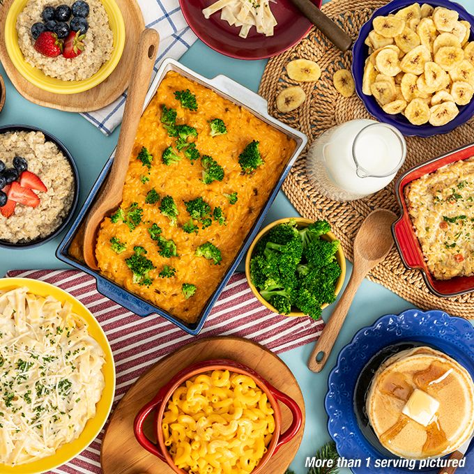 A mother fills her daughter's plate with creamed corn for Christmas dinner.