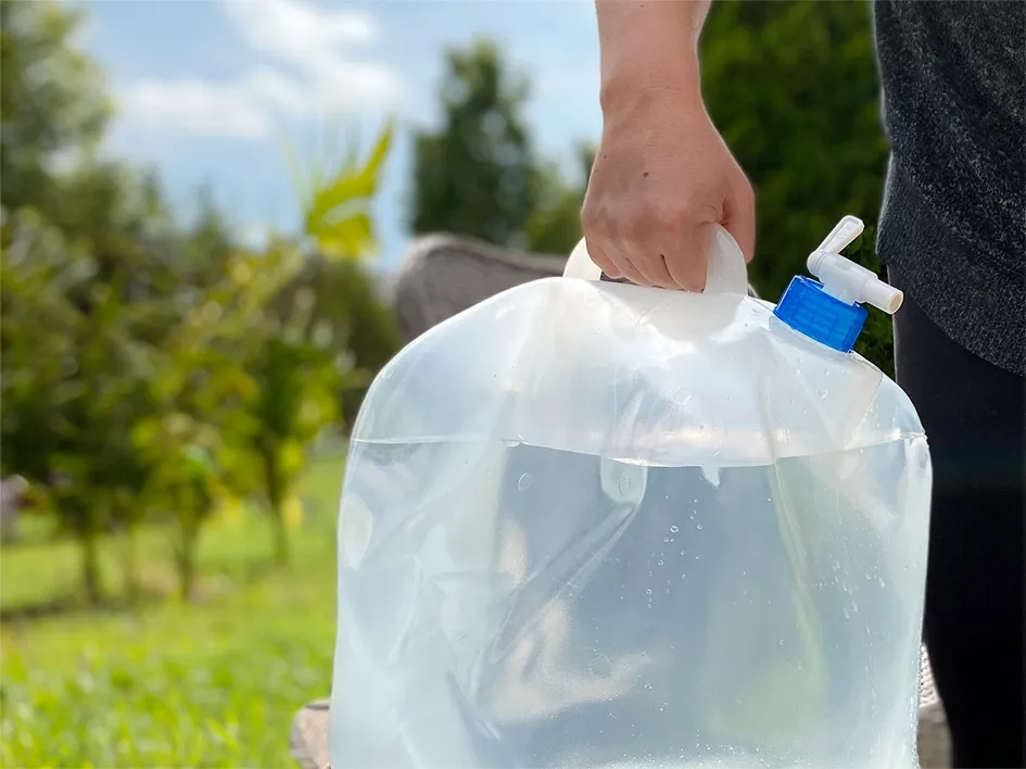 Water Tote A man carrying a water tote with a spigot