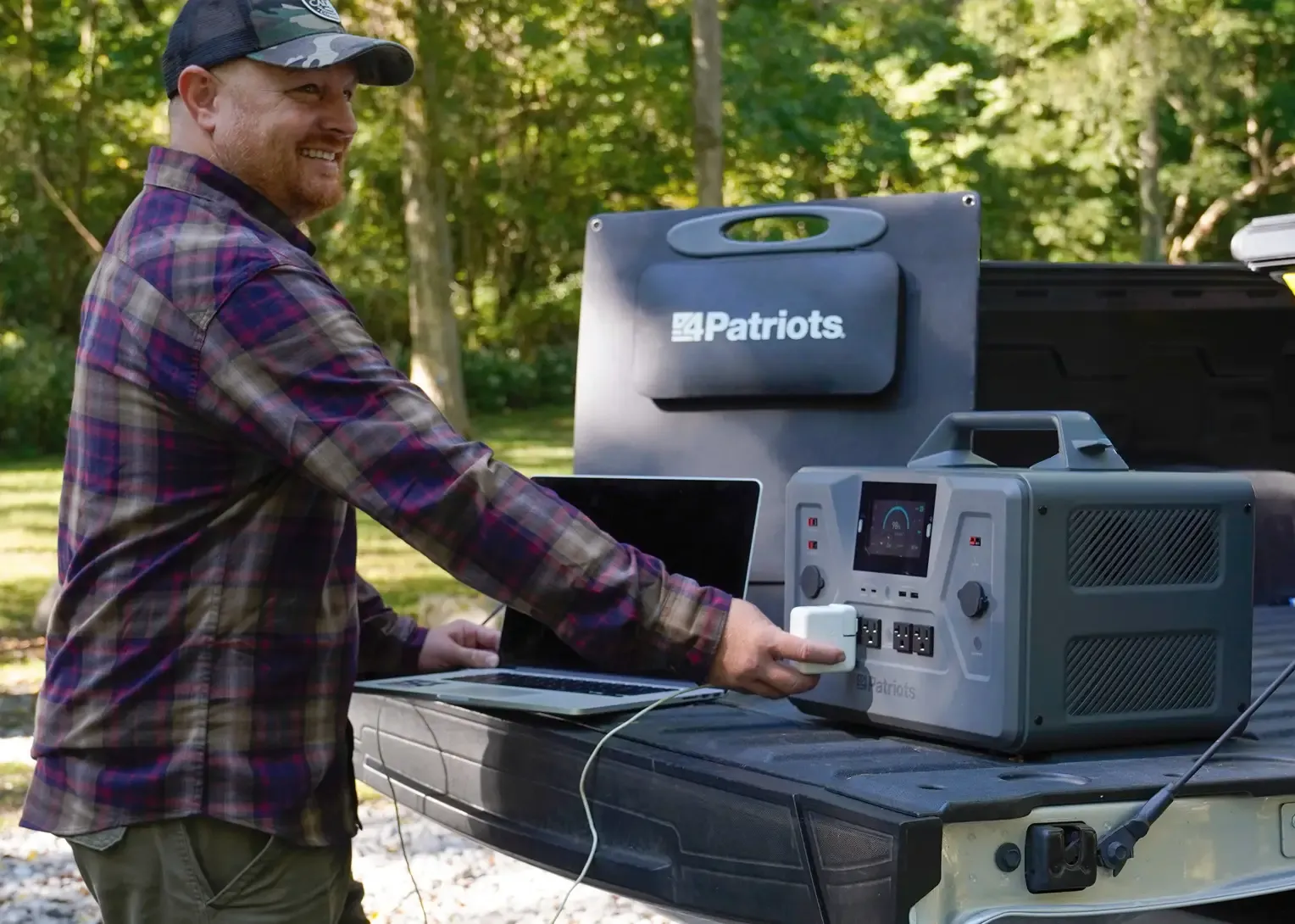 Patriot Power Solar Generator 2500X powering camp supplies A 4Patriots portable power generator set up at a campsite, powering a coffee pot while connected to a vehicle. The display shows 94% charge, with a camping chair and trees in the background.