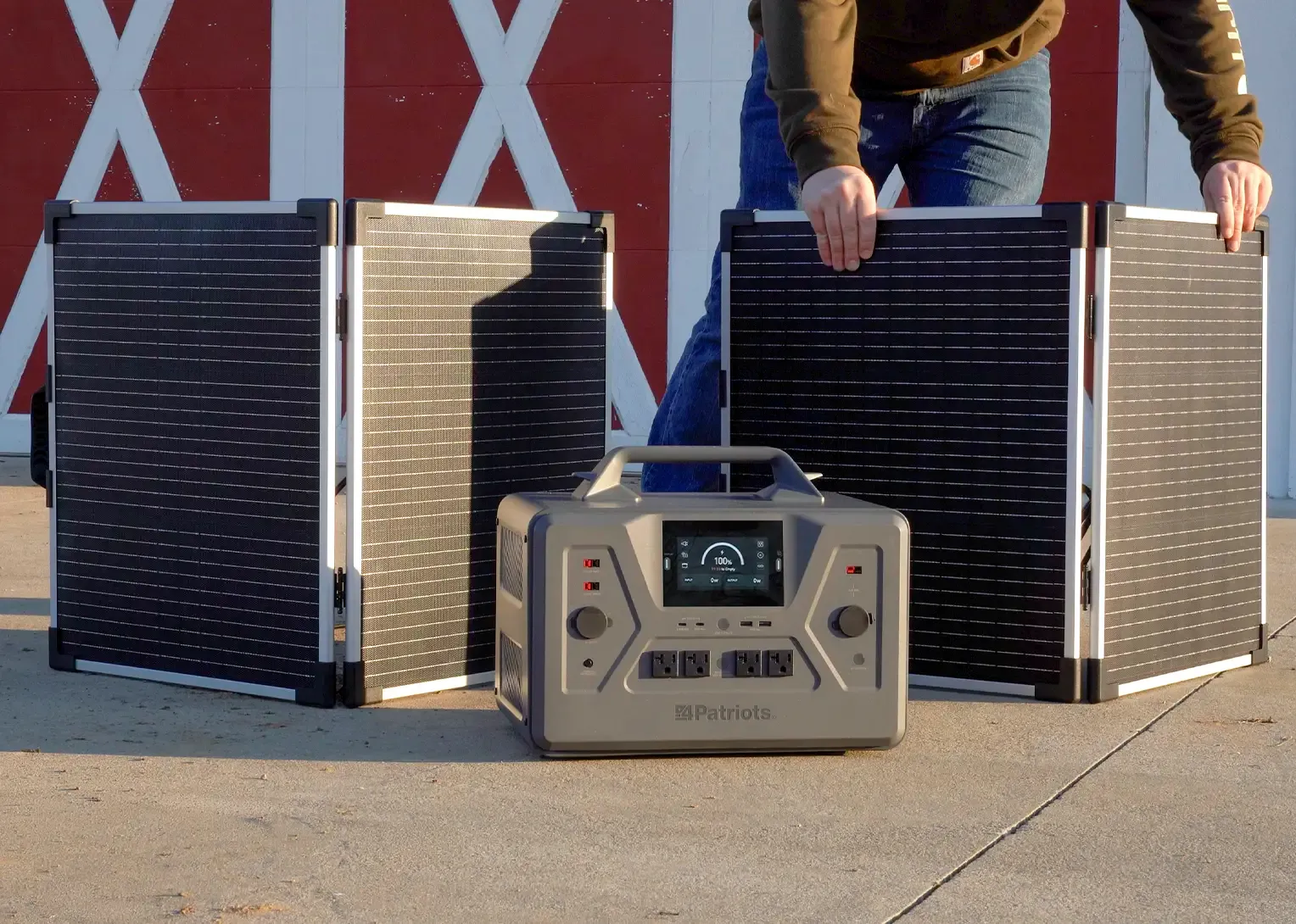A man with his Patriot Power Solar Generator 2200X and 2 Free Solar Panels