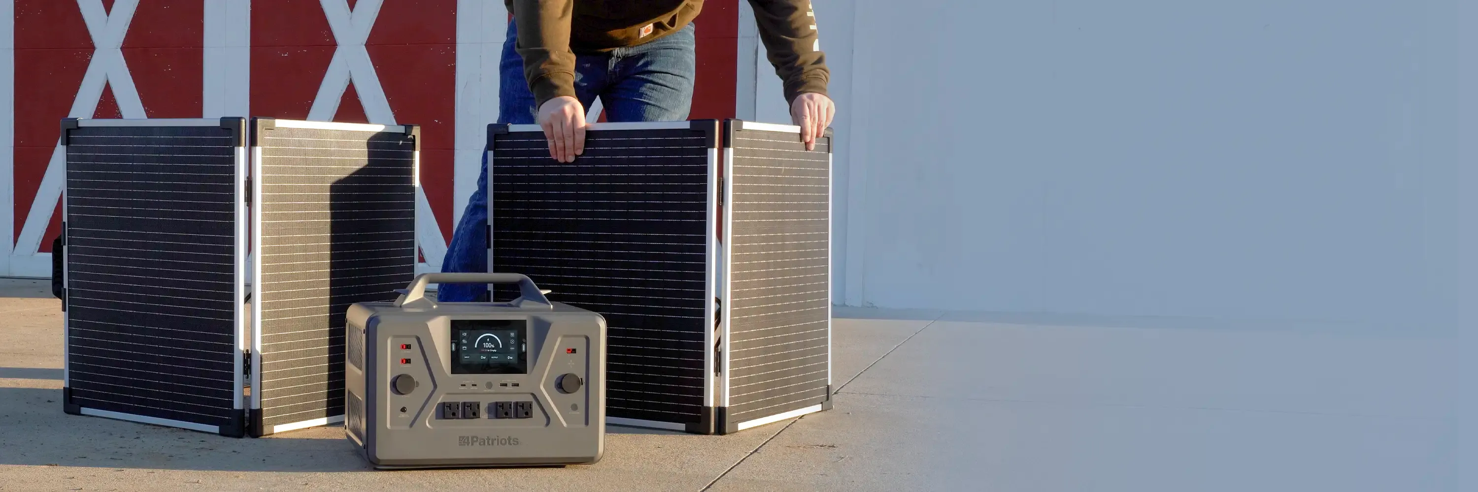 A man with his Patriot Power Solar Generator 2200X with 2 free Solar Panels