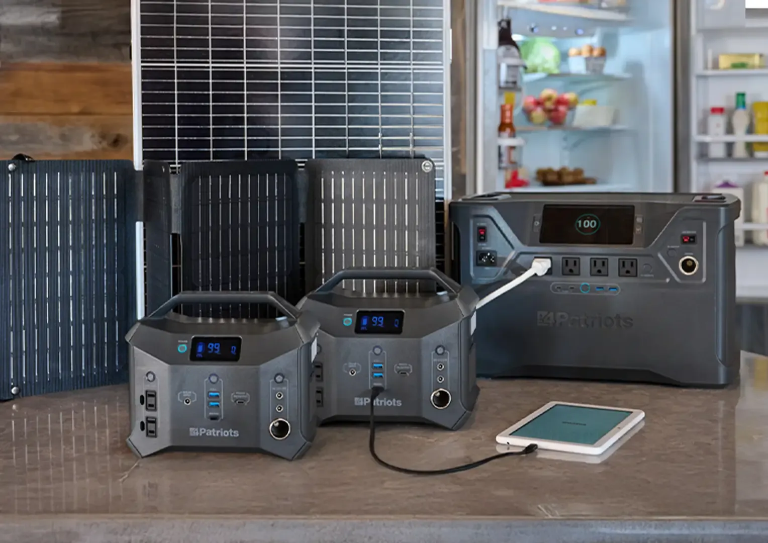 Patriot Power Generator 2000X + Sidekick Kit The 100W panel, 60W panel, the Patriot Power 2000X, and two Patriot Power Sidekicks charging a tablet device on a kitchen table.