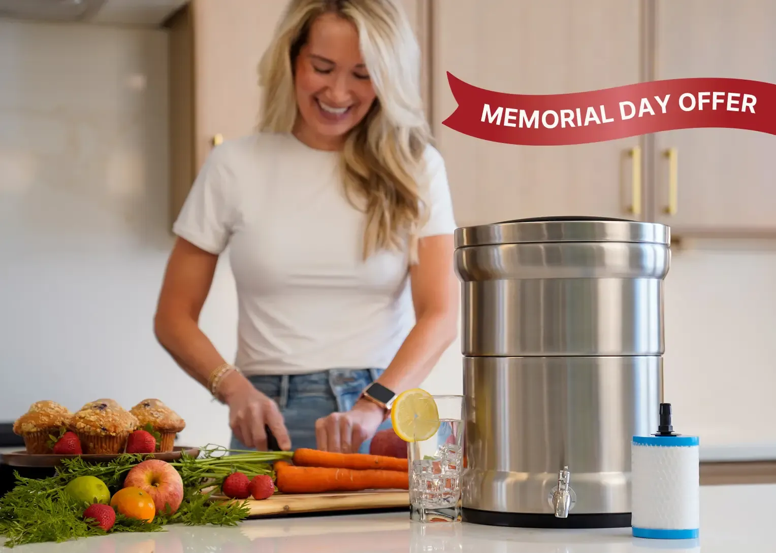 A woman in her kitchen cutting vegetables with a glass of water that was filter through her ultimate water filtration system. 