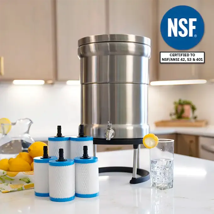 Ultimate Water Filtration System The Patriot Pure Ultimate Water Filtration system displayed on a kitchen counter, featuring a sleek stainless steel design with replaceable filters and a glass of water garnished with a lemon slice.