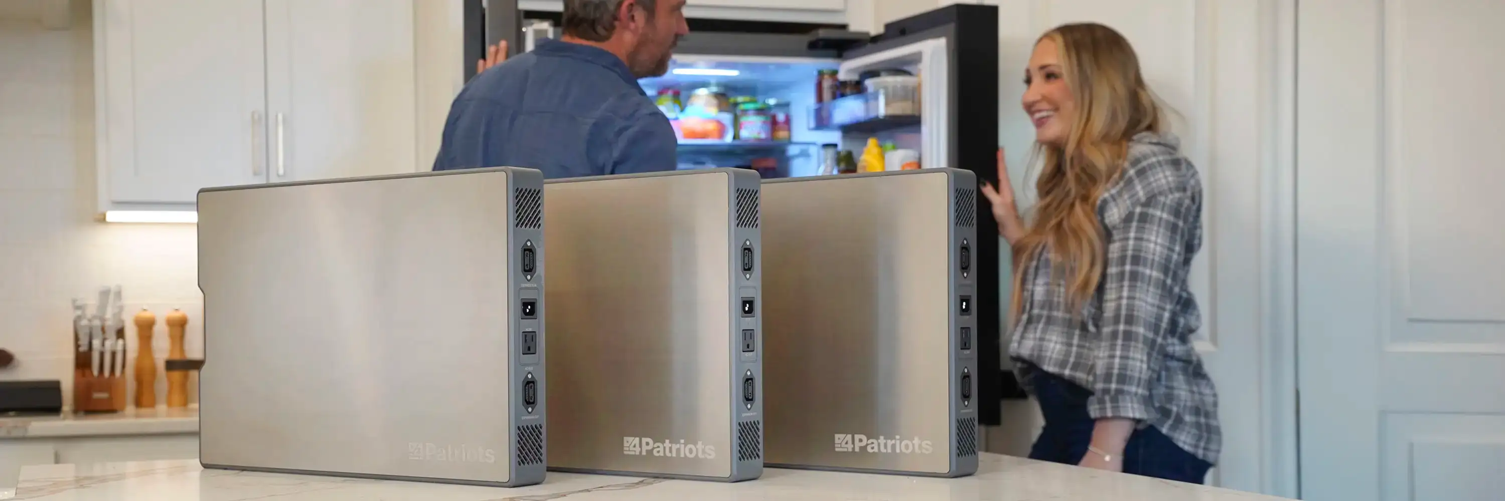 Person unfolding a large 200-watt solar panel outdoors next to a 4Patriots Patriot Power Generator 2200X on a wooden deck.